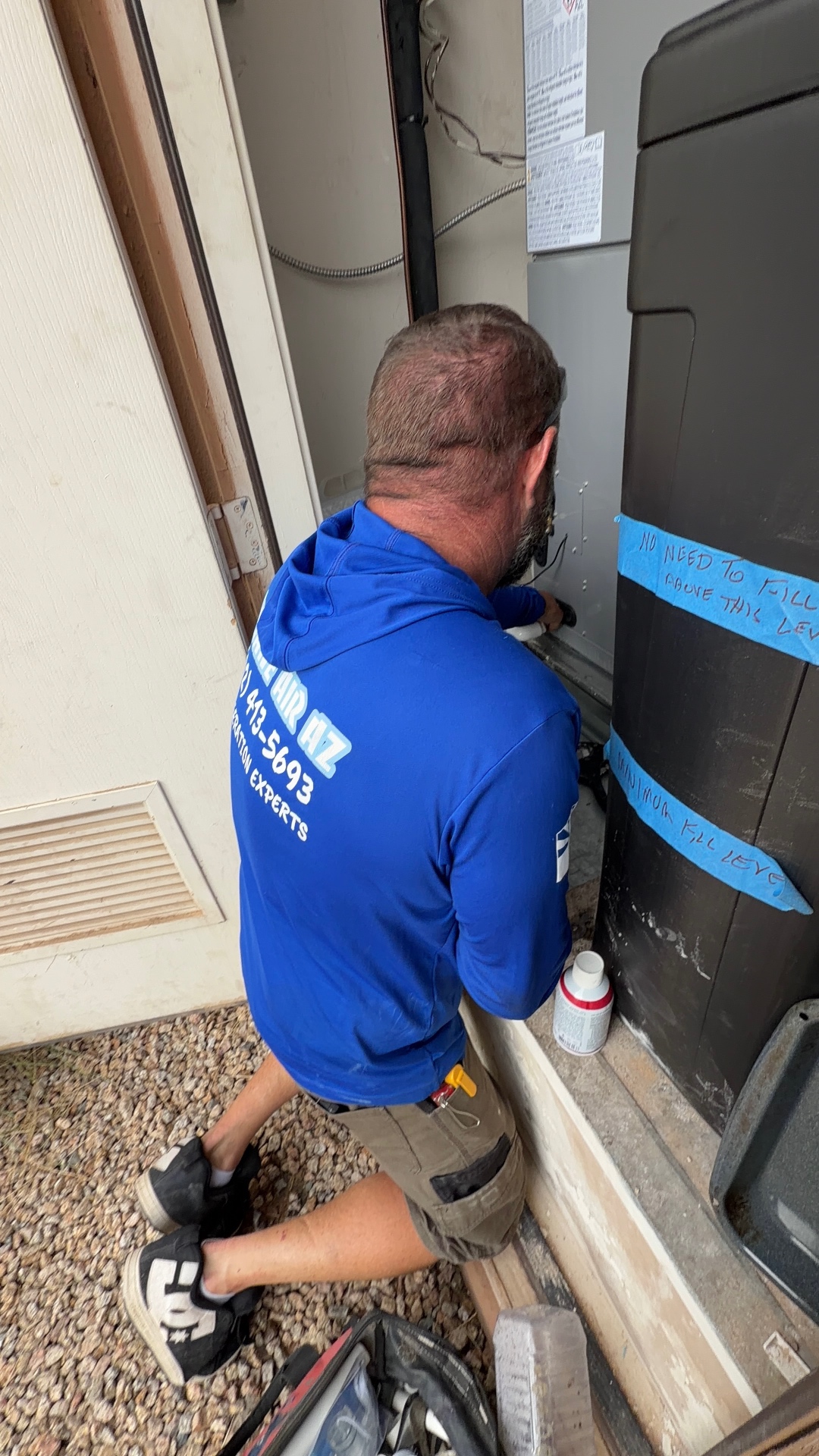 Insane Air technician diagnosing an air handler at a Phoenix home